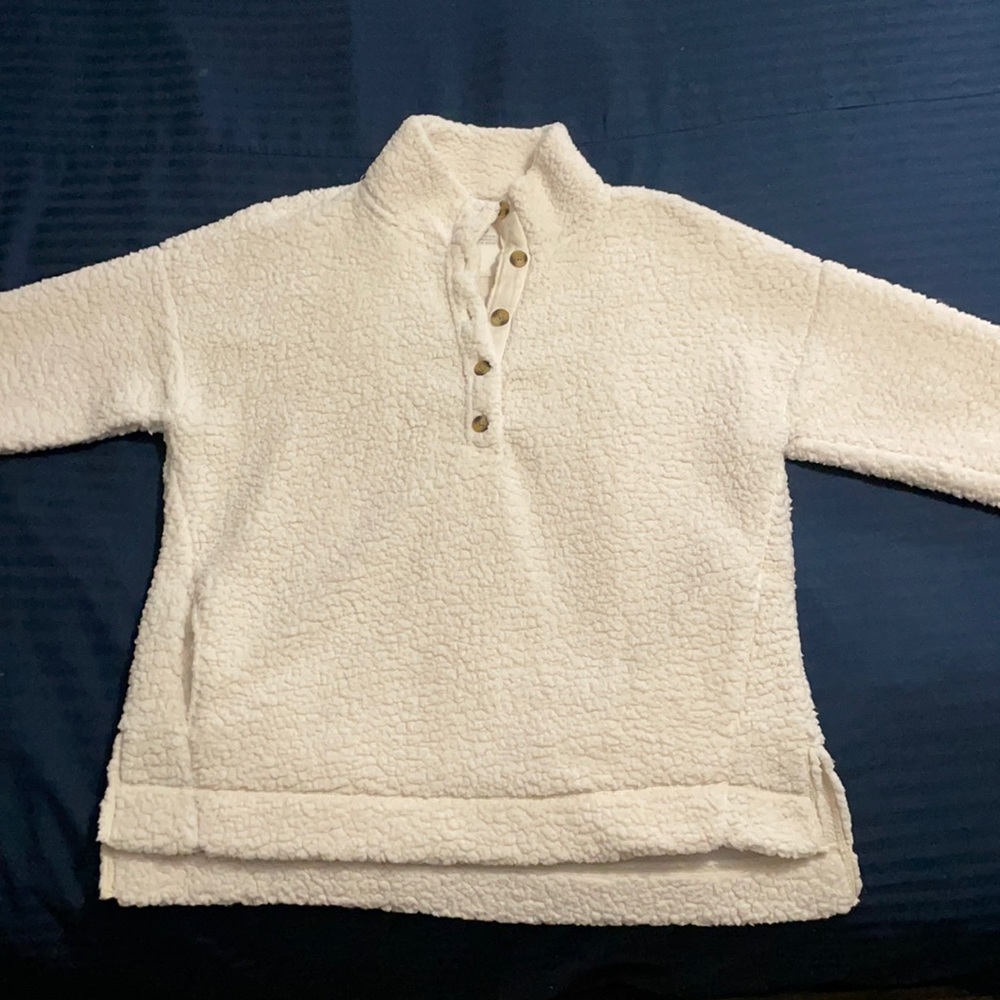 This is a white, fluffy pullover jacket.